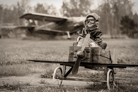 Young boy-pilot in the plane at the airport handmade autumnの写真素材