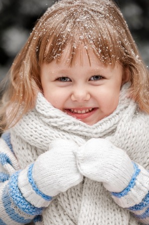 Portrait of a little girl in a winter sunny dayの写真素材