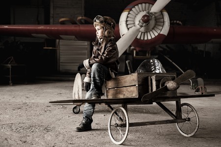 Young Aviator in a homemade aircraft in a hangar with these planesの写真素材