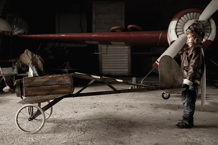 Young Aviator in a homemade aircraft in a hangar with these planesの写真素材