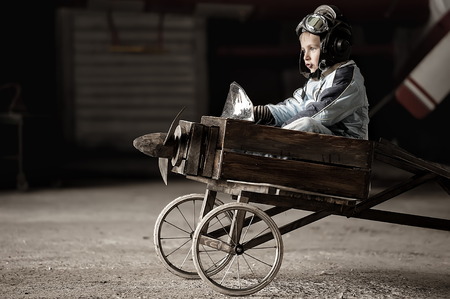 Young Aviator in a homemade aircraft in a hangar with these planesの写真素材