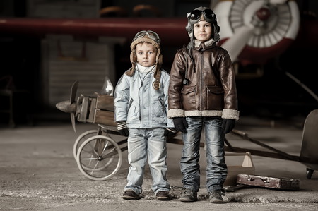 Young aviators in homemade aircraft in a large hangarの写真素材