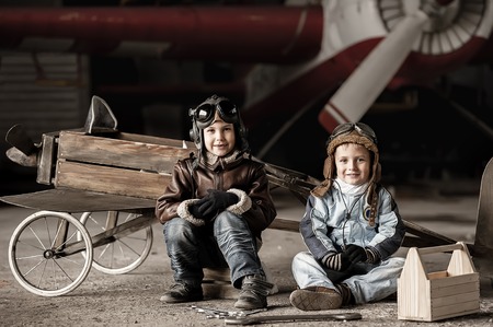 Young Aviators in a homemade aircraft in a hangar with these planesの写真素材