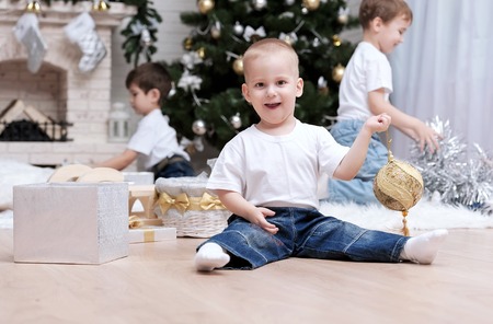 Children make out gifts at Christmas treeの写真素材