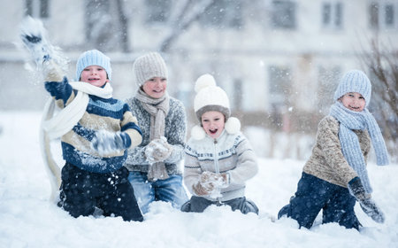 Group of kids playing in the snow in winter clear dayの写真素材