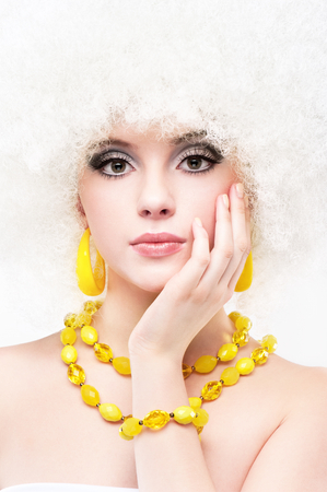 Portrait of a beautiful young blonde girl on a white backgroundの写真素材