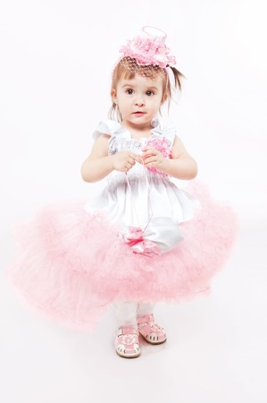 Little girl in a beautiful dress on a white backgroundの写真素材