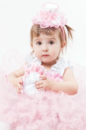 Little girl in a beautiful dress on a white backgroundの写真素材