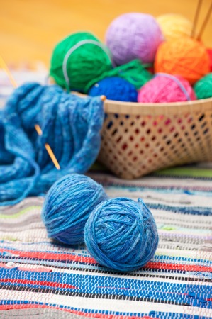 Color woolen clews for knitting on a floor boardの写真素材