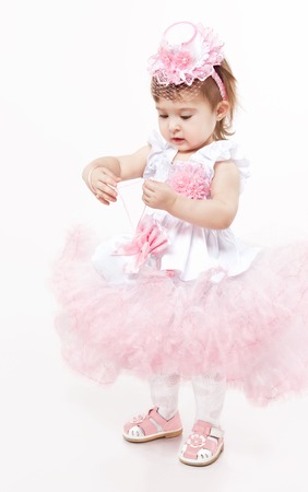 Little girl in a beautiful dress on a white backgroundの写真素材