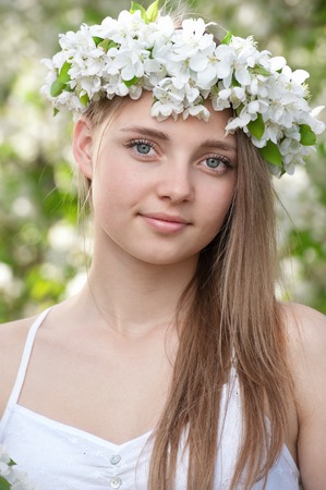 Portrait of a young girl in blossoming apple treesの写真素材