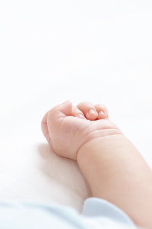 Hand of the child on a pillowの写真素材