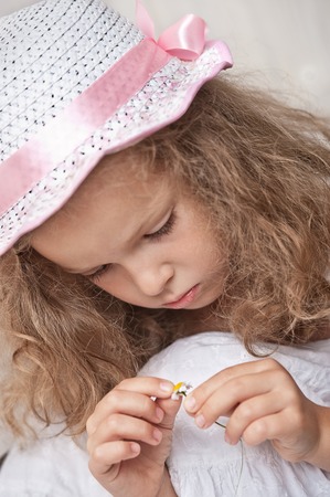 Little girl wonders for daisyの写真素材