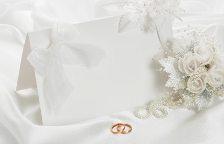 The wedding invitation with a bow on a white backgroundの写真素材