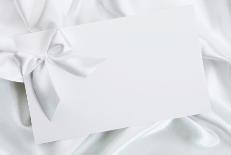 The wedding invitation with a bow on a white backgroundの写真素材
