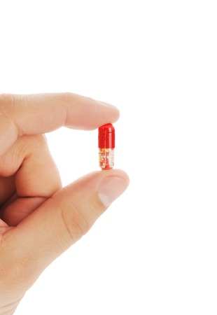 Pill in a hand of the person on a white backgroundの写真素材