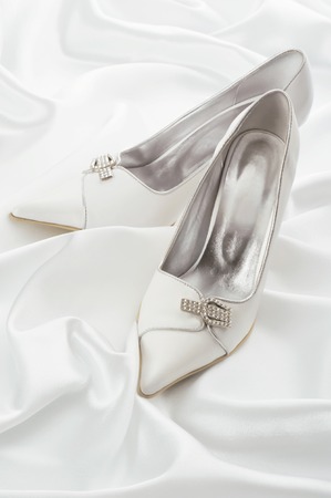 White shoes of the bride on a white backgroundの写真素材