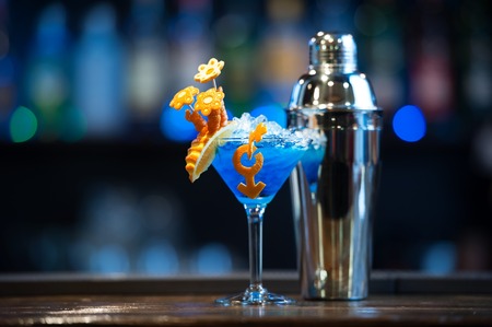 Cocktail with decoration and shaker on the barの写真素材