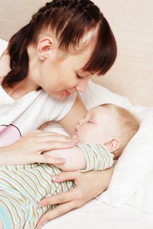 Mum near to the sleeping childの写真素材