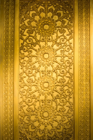 Thai art on the door in  Bung templeの写真素材