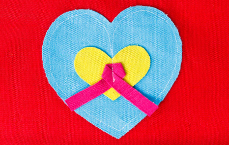 blue heart  on red backgroundの写真素材