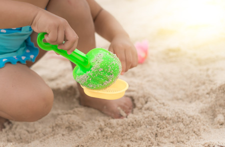 kid playing toy on beachの写真素材