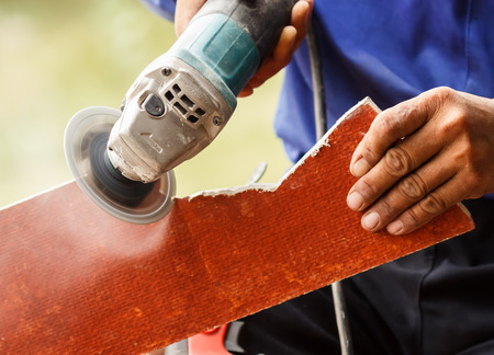 carpenter sawing wood with electric sawの写真素材
