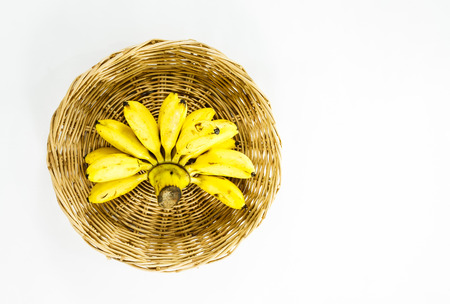 banana inside basket on isolated backgroundの写真素材