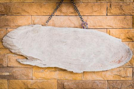 blank wood signboard with blick backgroundの写真素材