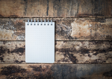 white notebook paper on grunge woodの写真素材