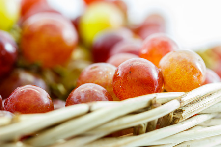 grapes in basket on isolated backgroundの写真素材