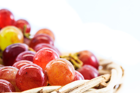 grapes in basket on isolated backgroundの写真素材