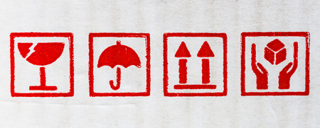 image closeup red fragile symbol on white boxの写真素材