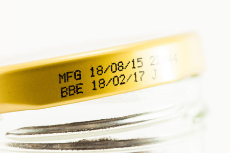 label expiration on bottle cap with white background