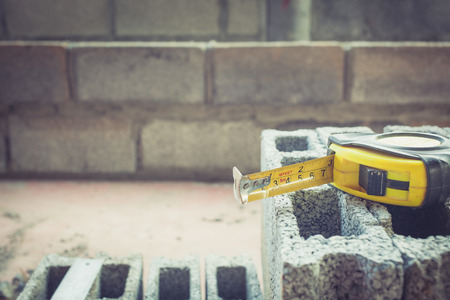 tape measure on brick constructionの写真素材