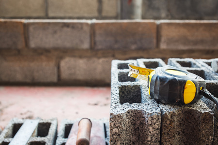 tape measure on brick constructionの写真素材