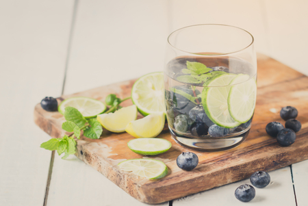 sweet blueberry lemonade and cocktail in glass on white wooden boardの写真素材
