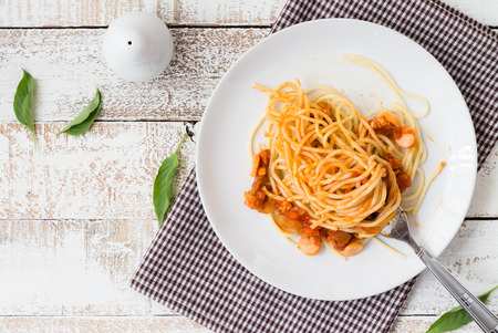 delicious homemade plate of spaghetti on white wooden board. top viewの写真素材