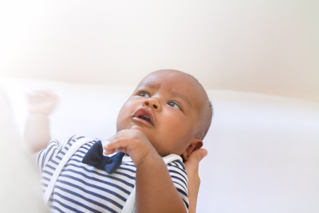 newborn asian boy baby sleeping on white furry clothの写真素材