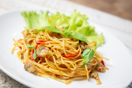 delicious homemade plate of spaghetti clams on white wooden board. top viewの写真素材