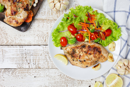 breast chicken salad serve with fresh vegetables on white dish. top viewの写真素材