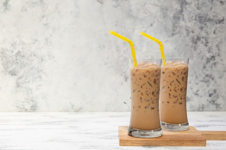 fresh ice coffee cup on the white wooden boardの写真素材