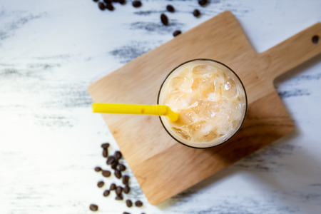 fresh ice coffee cup on the white wooden board. top viewの写真素材