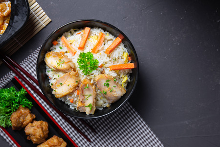 Fried rice with korean style chicken on black table. Top view.の写真素材