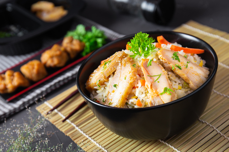 Fried rice with korean style chicken on black table. Top view.の写真素材