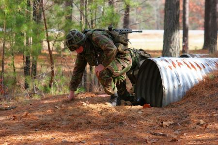 A marine emerging from a tunnel on an assault courseの写真素材