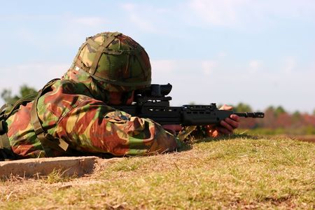 Firing an SA80 from a foxholeの写真素材