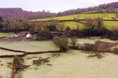 An English dairy farm with the winter morning frost still on the groundの写真素材