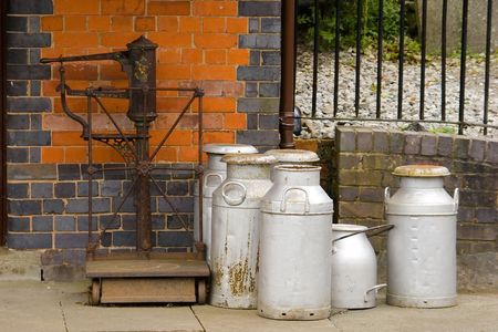 Milk churns waiting on the station of a historic preserved victorian railwayの写真素材