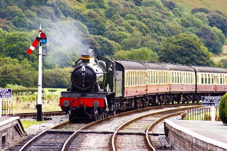 A steam train approaching the station on a preserved Victorian railwayの写真素材